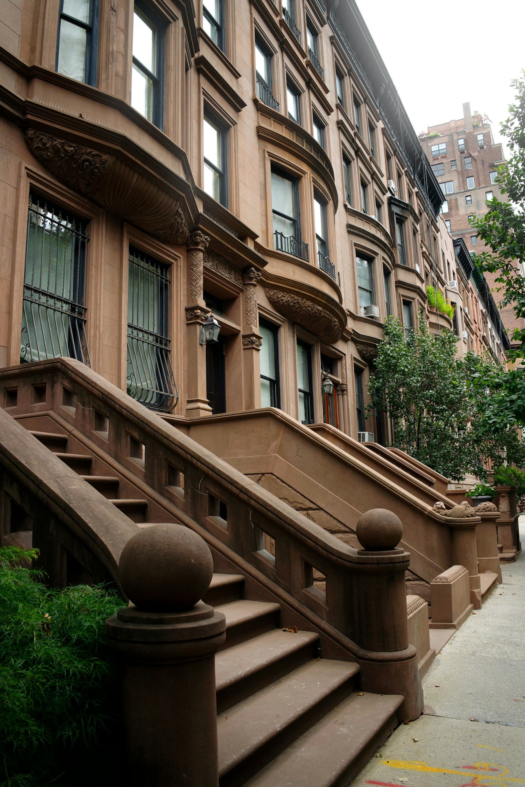 Row of New York City brownstones with stone stoops
