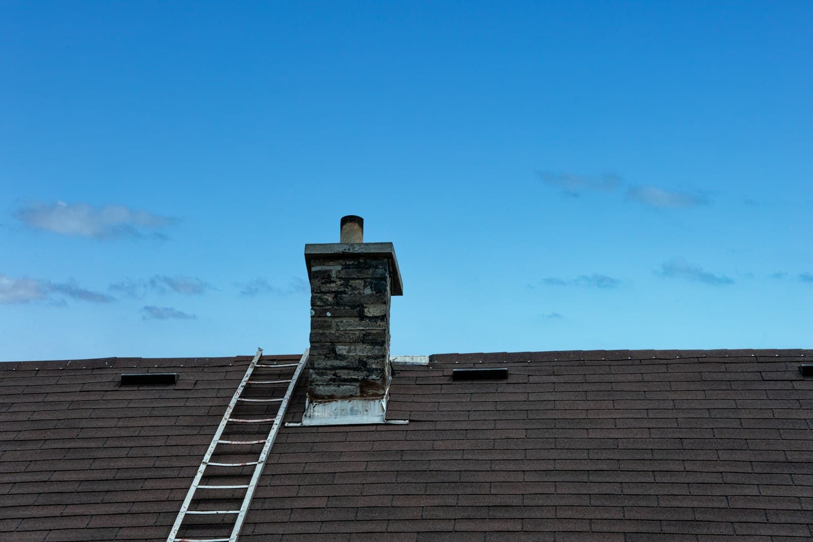 Stone chimney on a shingle roof
