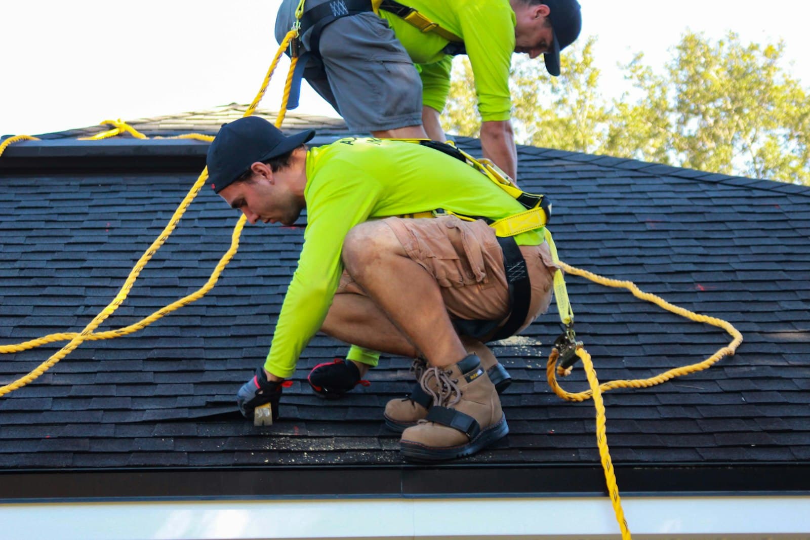 Roofer installing shingles