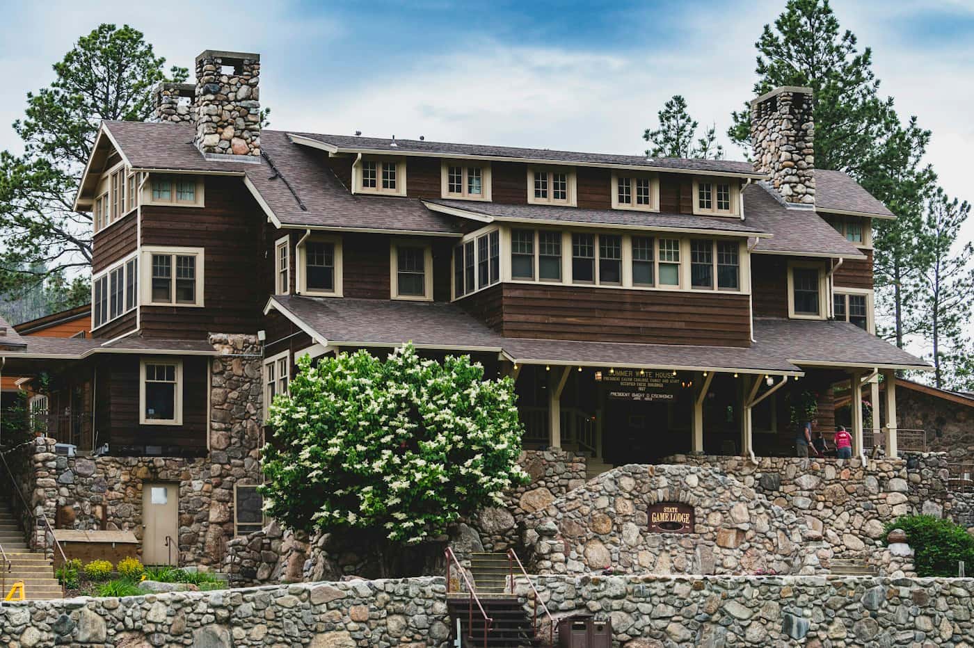 Stone and timber home with landscaped yard