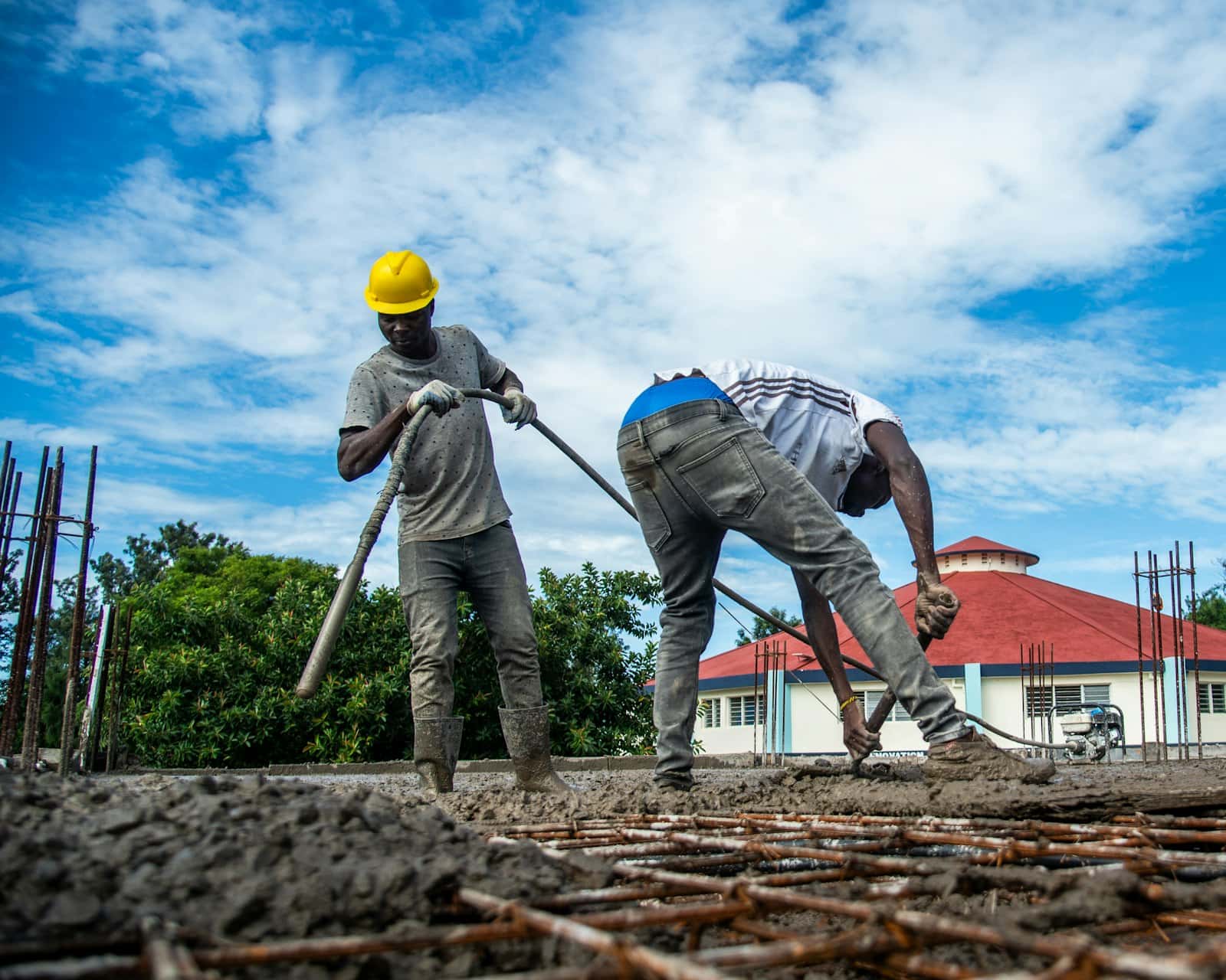 Crew pouring and leveling fresh concrete