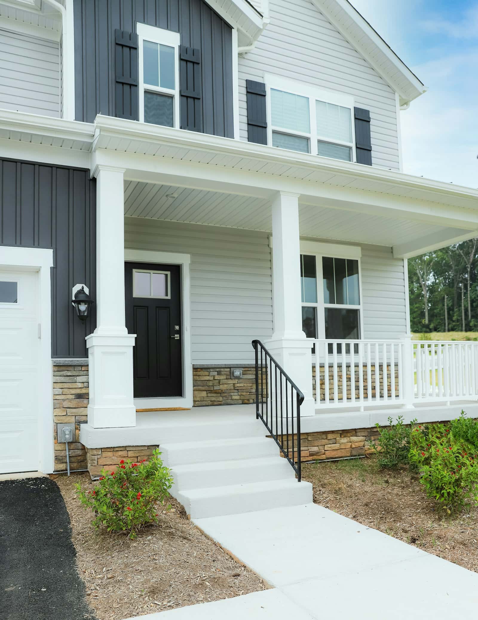 Home exterior with new siding, porch and stone accents